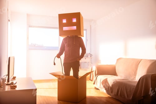 Preview: Faceless man with box on head holding power cord