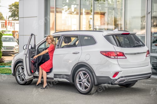 Visualização: Mulher sorridente sentada no banco do motorista no carro