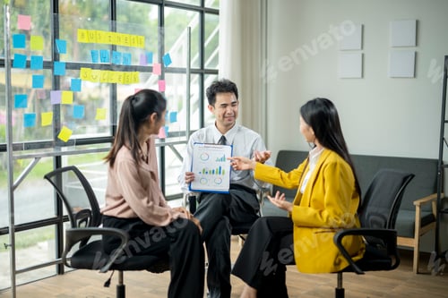 Preview: Three people are sitting in chairs in a room