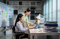 Preview: Two Asian young businesswoman work in office workplace with happiness.