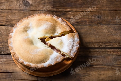 Preview: Piece of fresh rhubarb and strawberry pie with cream nearby