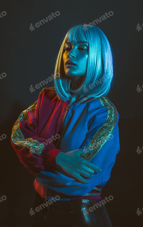 Preview: Young woman with grey hair dancing and celebrate. Colored gel portraits