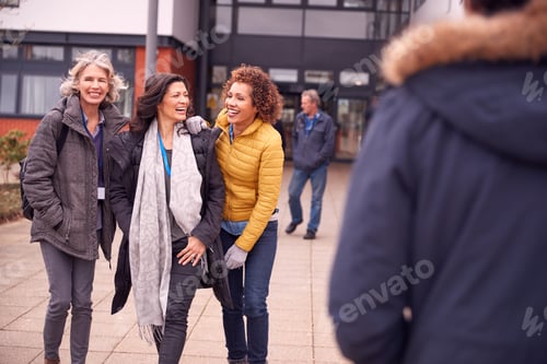 Preview: Group Of Smiling Female Mature Students Walking Outside College Building
