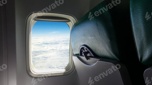 Preview: Airplane seat and windows inside an aircraft. Clouds airplane passenger window.