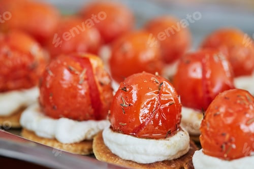 Preview: Appetizers with ricotta cheese and cherry tomatoes on serving tray