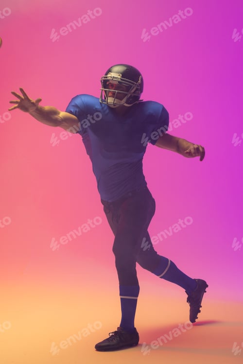 Preview: Caucasian male american football player wearing helmet with neon pink lighting
