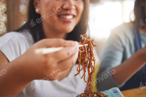 Preview: Asian, noodles and woman at a restaurant eating for dinner or lunch meal using chopsticks and feeli