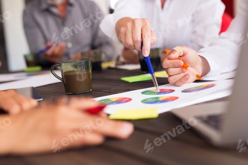 Preview: Business people analyzing charts during meeting