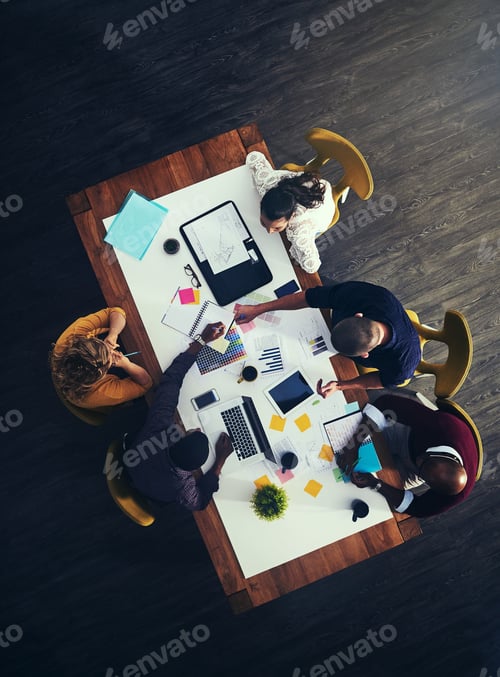 Preview: High angle shot of a group of businesspeople having a meeting in a modern office