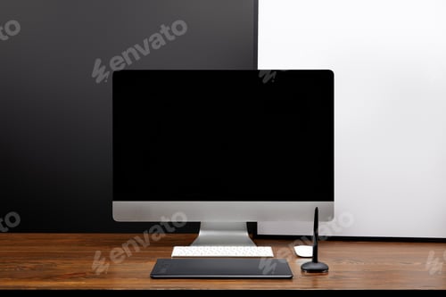 Preview: close up view of designer workplace with blank computer screen and graphic tablet on wooden tabletop