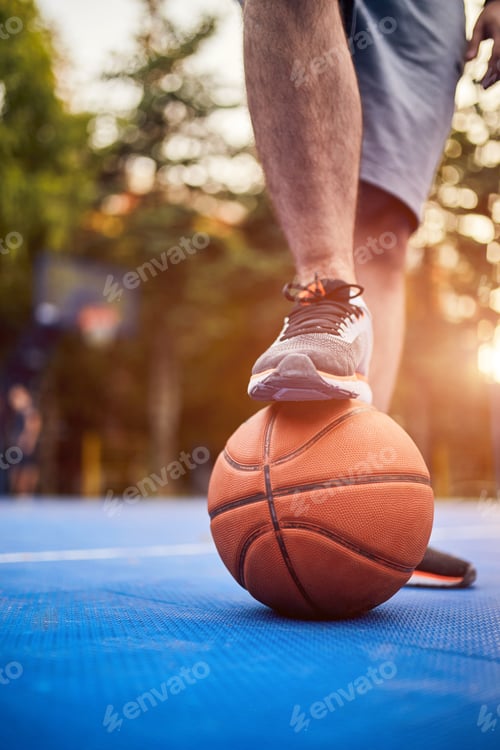 Preview: Man Making A Pause With Basketball Ball On The Urban City Court.