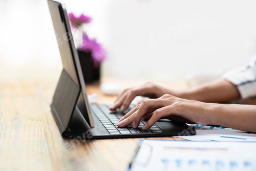 Preview: Close up of woman hand Printing using the tablet computer at the office.