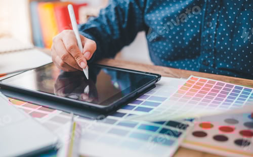 Preview: Graphic designer architects who work with laptops and color comparison tables for design work.