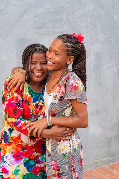 Preview: African American women mother and daughter hugging in the street