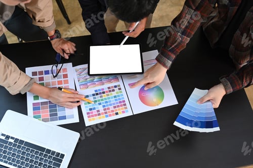 Preview: Overhead view group of young graphic designer working with color swatches together.