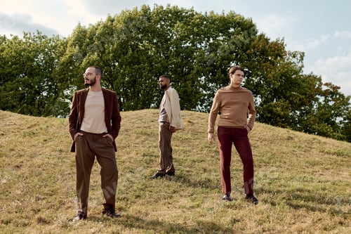 Preview: Handsome men in stylish autumn attire pose in a serene field surrounded by autumn trees