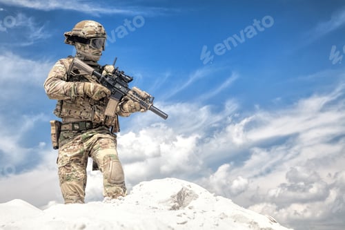 Preview: Airsoft player witt gun taking part in war games
