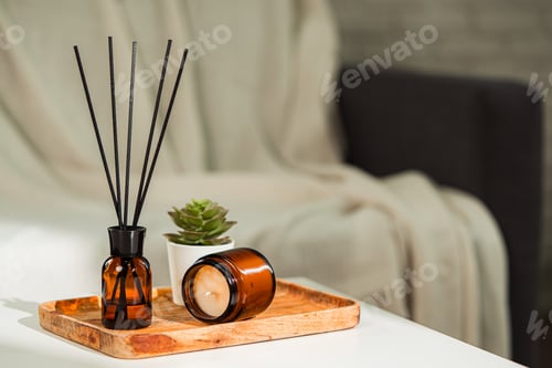 Preview: Aromatic reed freshener and candle on table in room