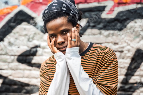 Preview: Portrait of young handsome stylish black man with natural hair afro dreadlocks. Afroamerican guy. St