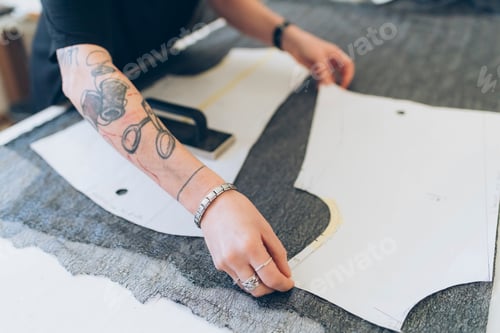 Preview: Fashion designer laying out dressmaker's pattern