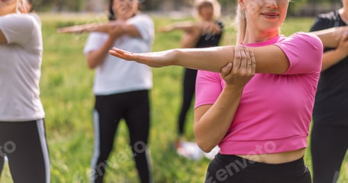 Preview: Group of women do warm-up outdoors on the grass