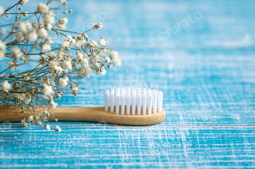 Preview: Natural eco-friendly bamboo toothbrush on a blue background, copy space.