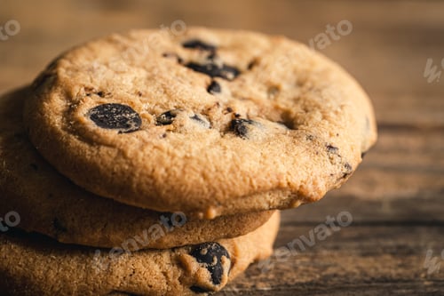 Preview: Chocolate chip cookies close up on a wooden background.
