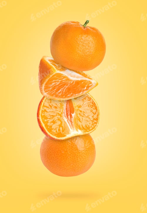 Preview: Ripe juicy tangerines falling on orange background