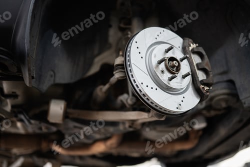 Preview: Close-up of car brake disc in an auto repair shop setting