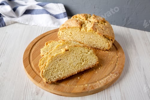 Preview: Homemade Irish Soda Bread on a bamboo board, side view.