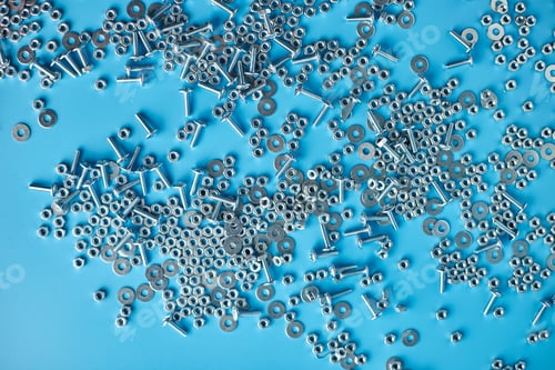 Preview: Top view, flat lay Metal screw, nuts and bolts on blue background,
