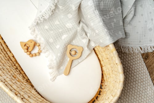 Preview: Muslin blanket and wooden toys in baby cradle