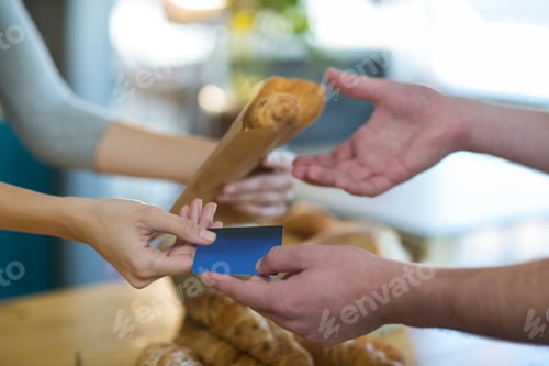 Preview: Waitress Giving Parcel To Customer At Counter In Cafe