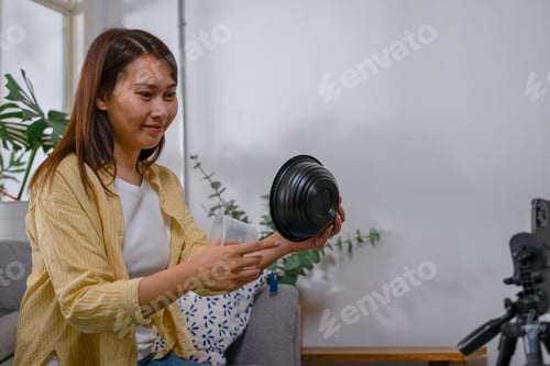 Preview: The East Asian woman is choosing garbage for recycle.