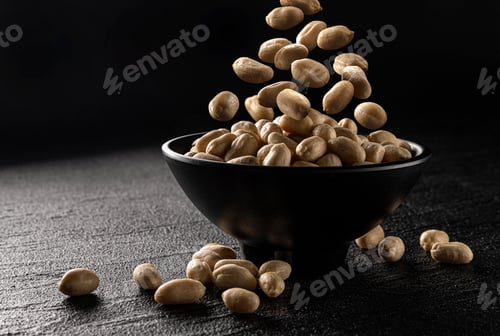 Preview: Falling peanut on black background with copy space