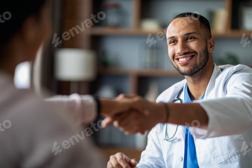 Preview: Handsome arabic doctor shaking female patient hand