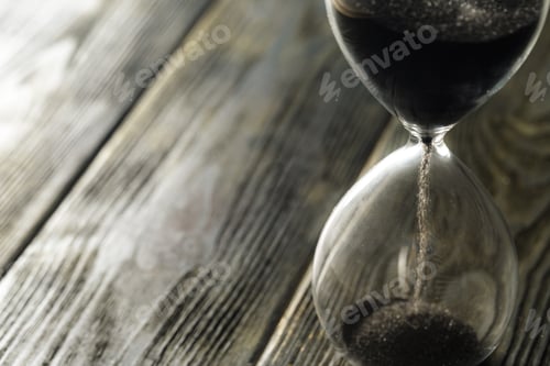 Preview: Modern hourglass on wooden background