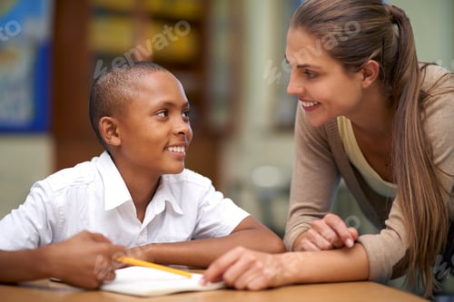 Preview: Youre my favorite teacher. Shot of a teacher helping her student with his work in the classroom.
