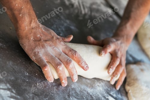 Preview: Baker preparing bread. Close up of hands kneading dough.