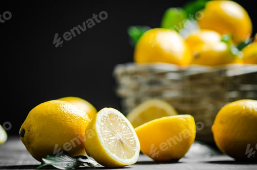 Preview: Fresh lemons. On black table.