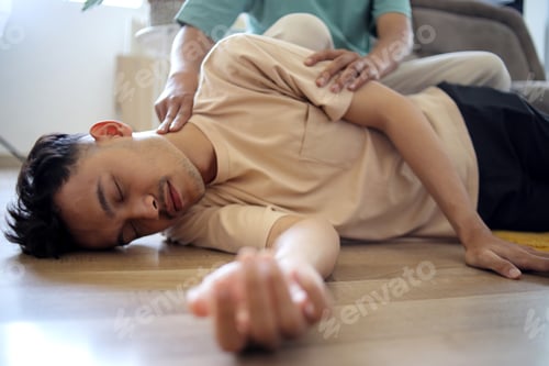 Preview: Man Doing CPR First Aid, Checking Pulse to Asian Guy at Home First Aid Emergency