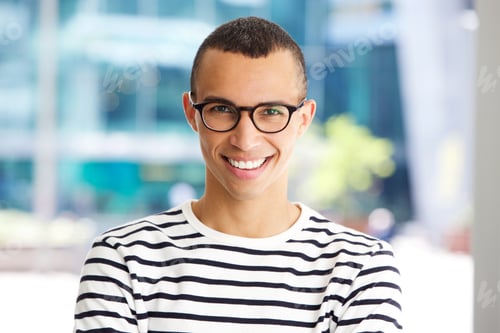 Preview: horizontal portrait of handsome young man smiling with glasses