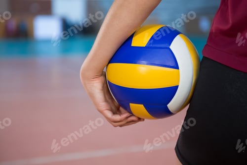 Preview: Female player holding volleyball in the court