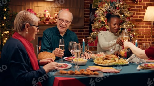 Preview: Happy elderly man talking with wife while enjoying Christmas dinner table with close family members