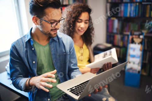Preview: Group of college students studying in the school library
