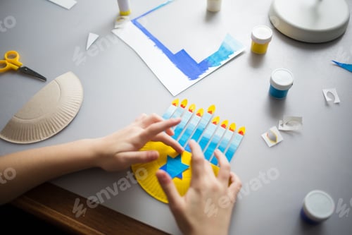 Preview: paper craft for kids. girl makes diy hanukkah candle holder. create art for children