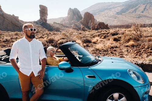 Preview: a woman and a man wearing glasses in a convertible car on a trip to the island of Tenerife. The