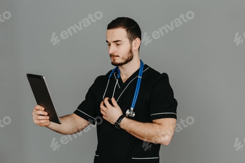 Preview: Portrait of a friendly doctor. Isolated on gray