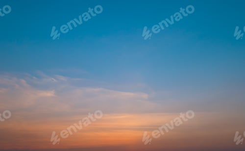 Preview: Bright orange sunset sky background with gentle colorful clouds, soft focus