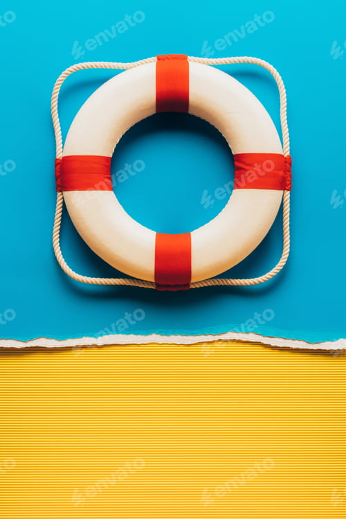 Preview: top view of red and white life saver on blue and yellow paper background
